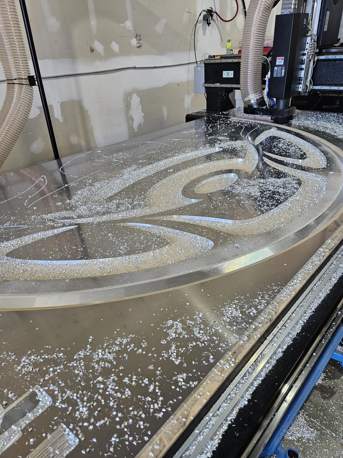 A large aluminum art panel being cut on our 5 × 10 ft CNC router