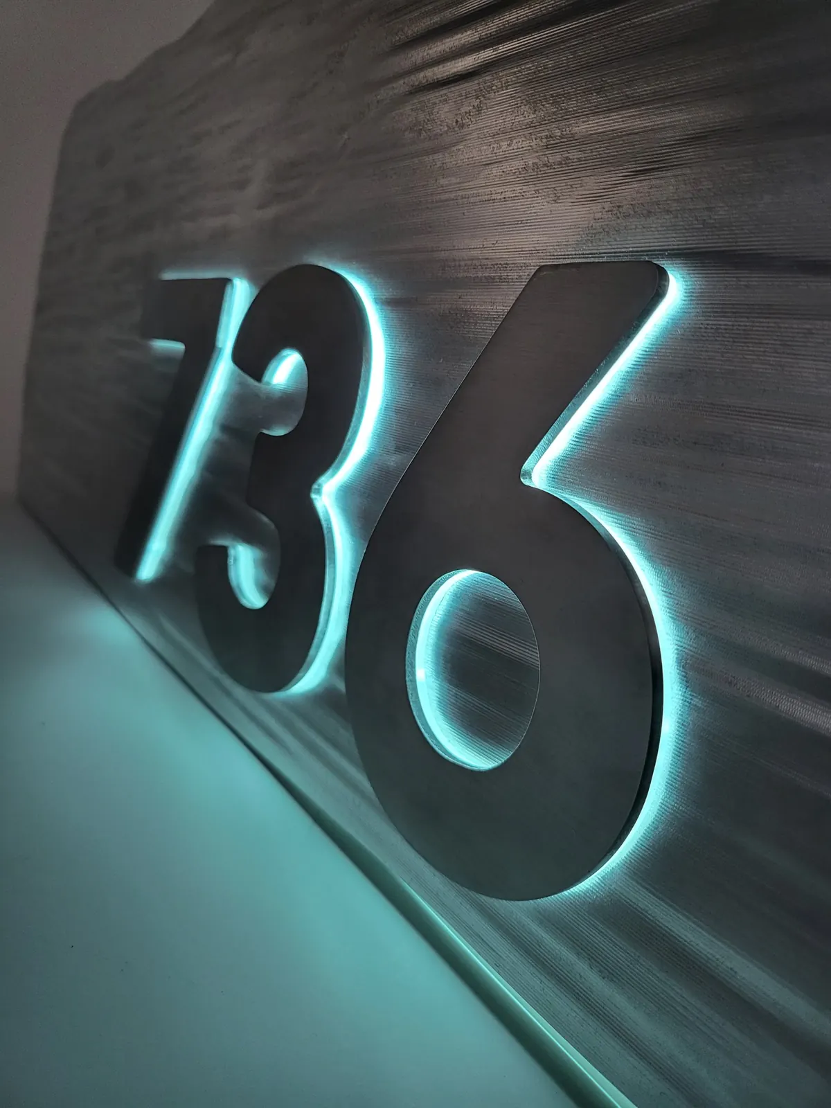 Backlit stone-texture address sign, architectural work by Spark Fabrication in Richmond, BC