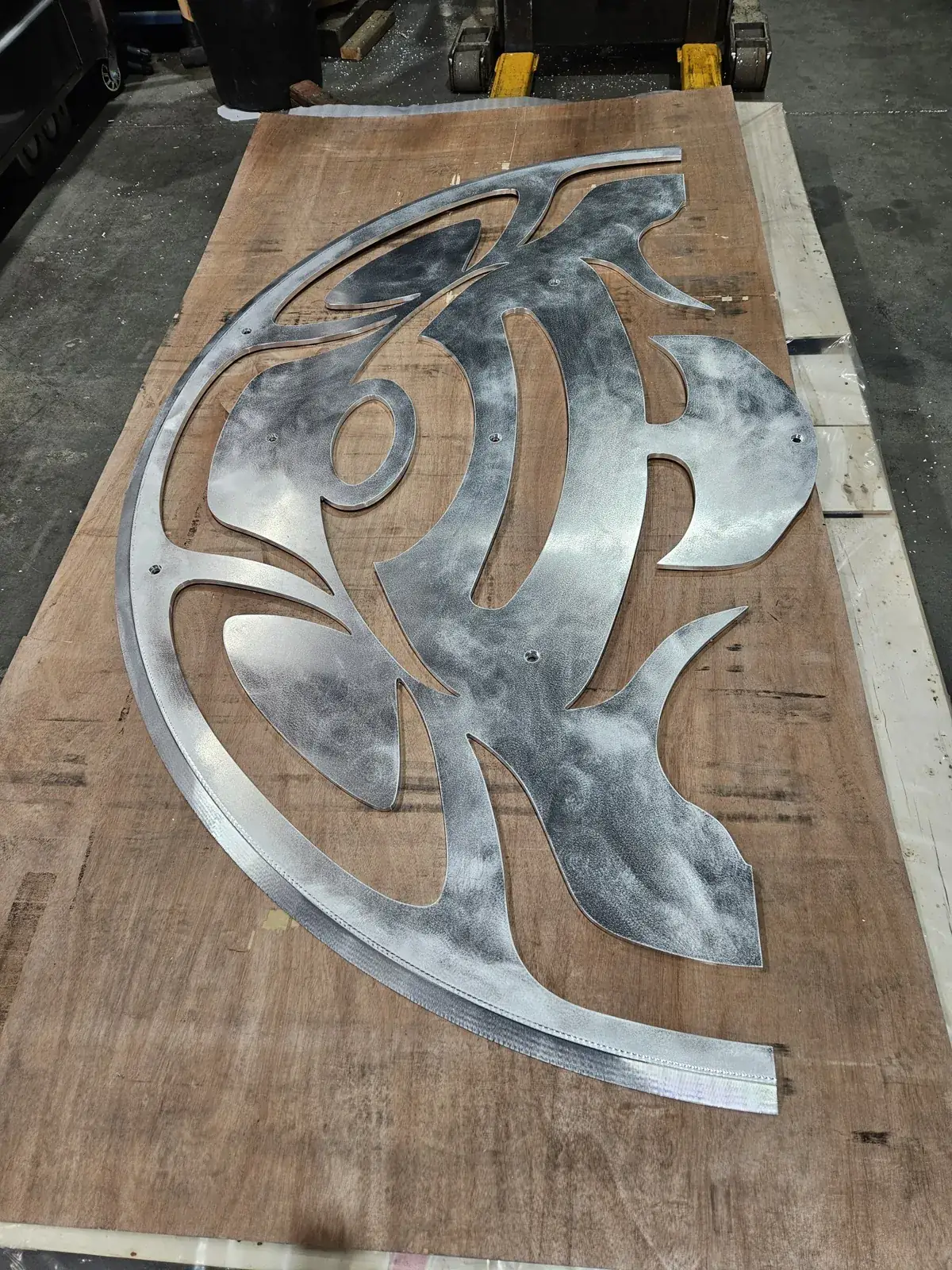 A large decorative aluminum panel cut in one piece