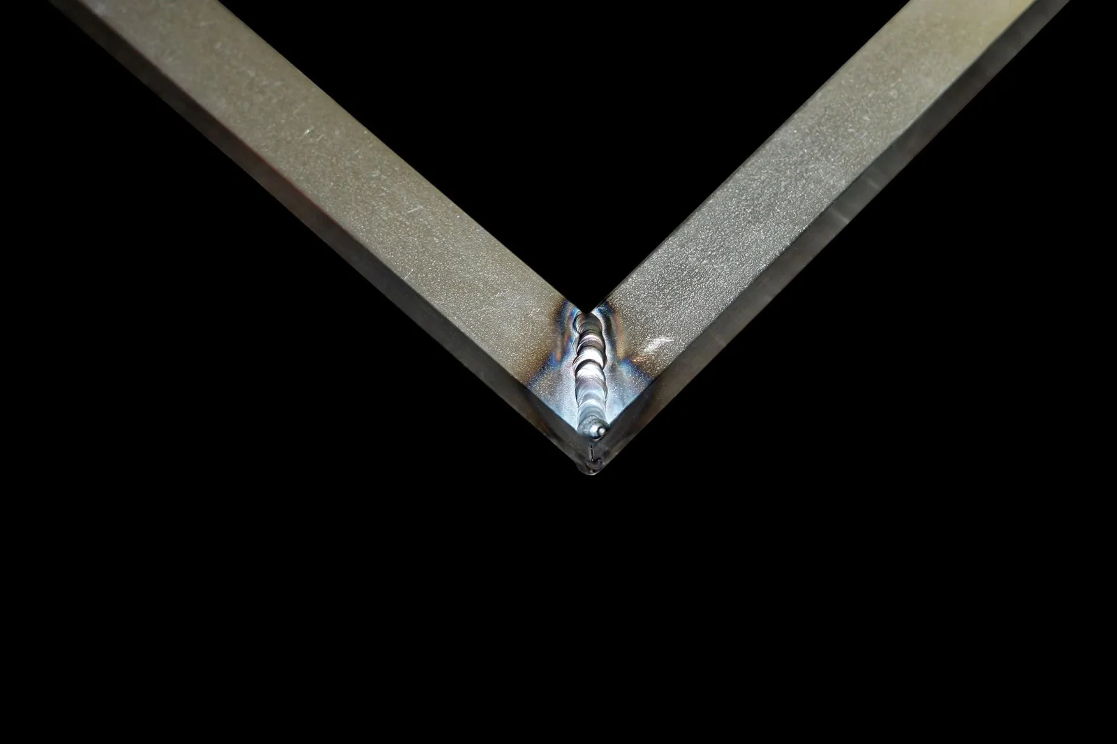 Close-up of a clean TIG-welded corner joint on a steel frame
